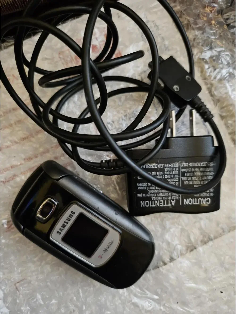 Nice vintage Samsung flip cell phone t-mobile. With Charger. Powers on & charges